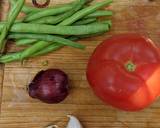 A picture of step 1 of Green beans (cumin, tomato + garlic).