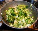 A picture of step 5 of Fried rice topped with green veggies.