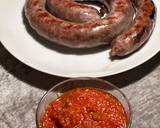 A picture of step 5 of Boerewors with mashed potatoes served with a tomato chili relish.