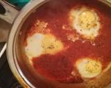 A picture of step 3 of Shakshouka (eggs in tomato and basil sauce).