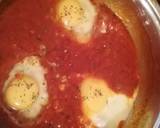 A picture of step 3 of Shakshouka (eggs in tomato and basil sauce).